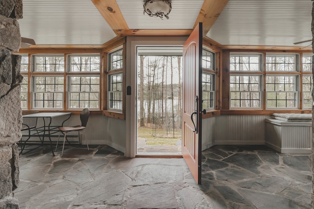 Sunroom interior with crazy paving stone floor and lake view